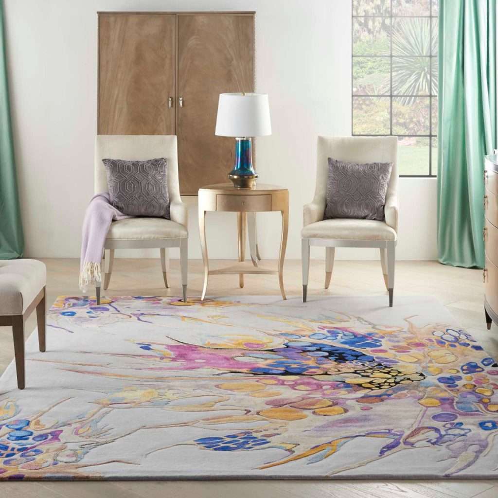 Living room scene with two chairs, a table lamp, and a colorful area rug