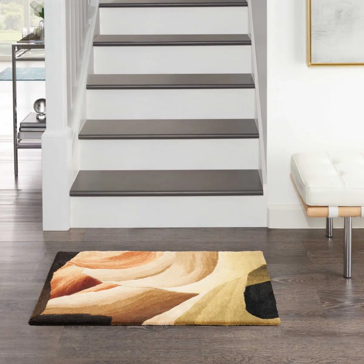 Decorative area rug with abstract design on floor near stairs